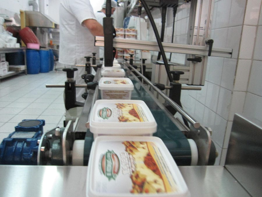 close-up of boxes on conveyor belt, part of labeling machine at 'M. Kosmidis' workshop